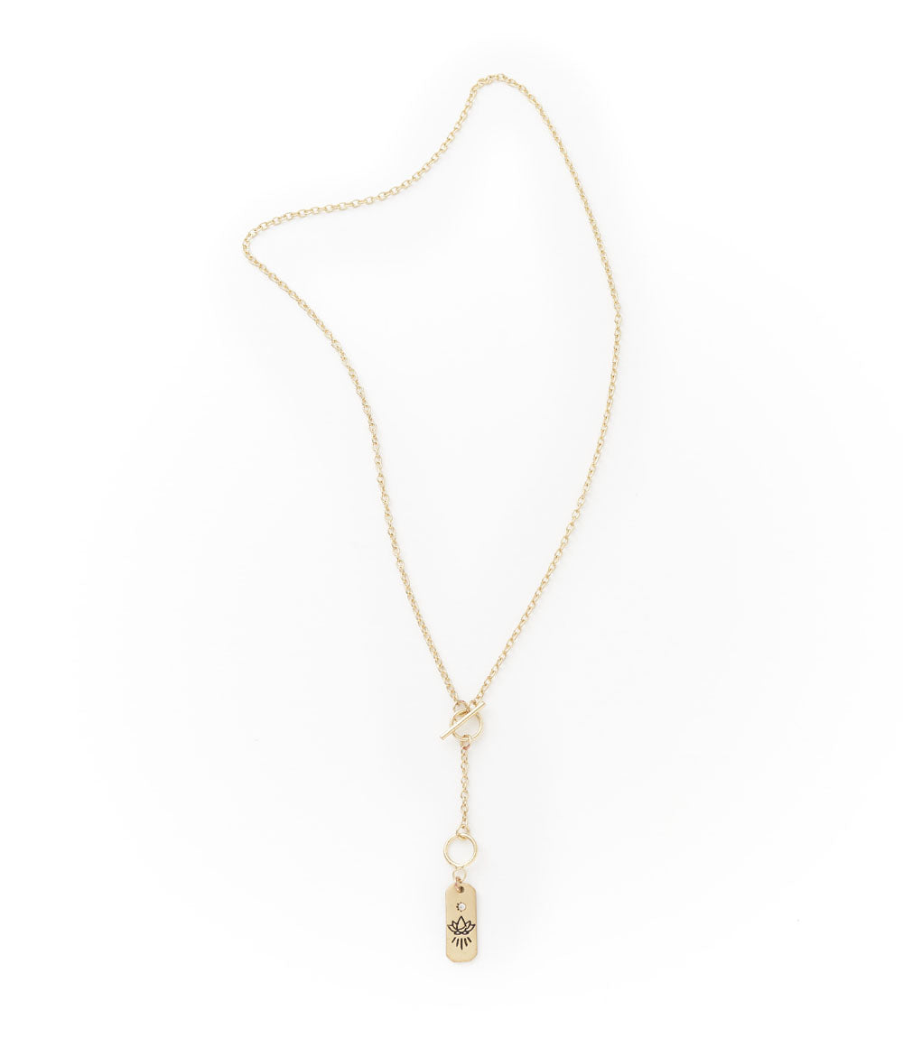Gold necklace with a small pendant on a white background