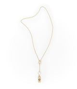 Gold necklace with a small pendant on a white background