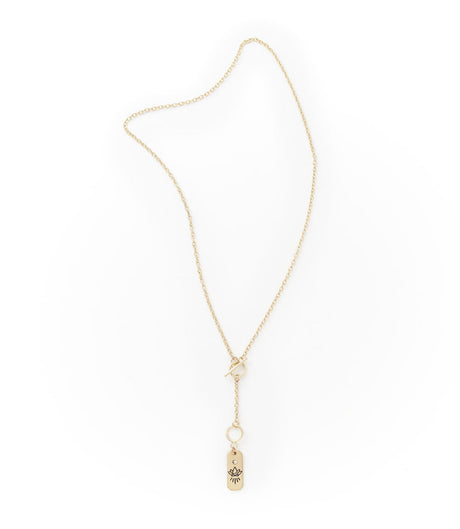 Gold necklace with a small pendant on a white background