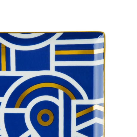 Square plate with geometric blue, gold, and white pattern on a white background