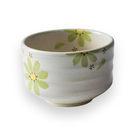 The Green Flowers Ceramic Matcha Bowl is a white ceramic piece crafted with Minoyaki pottery techniques, featuring a green and yellow floral design on a striking black background.