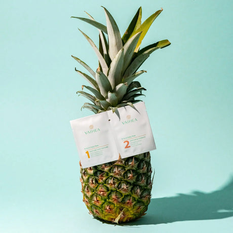 Pineapple with Vatika skincare products attached on a light blue background