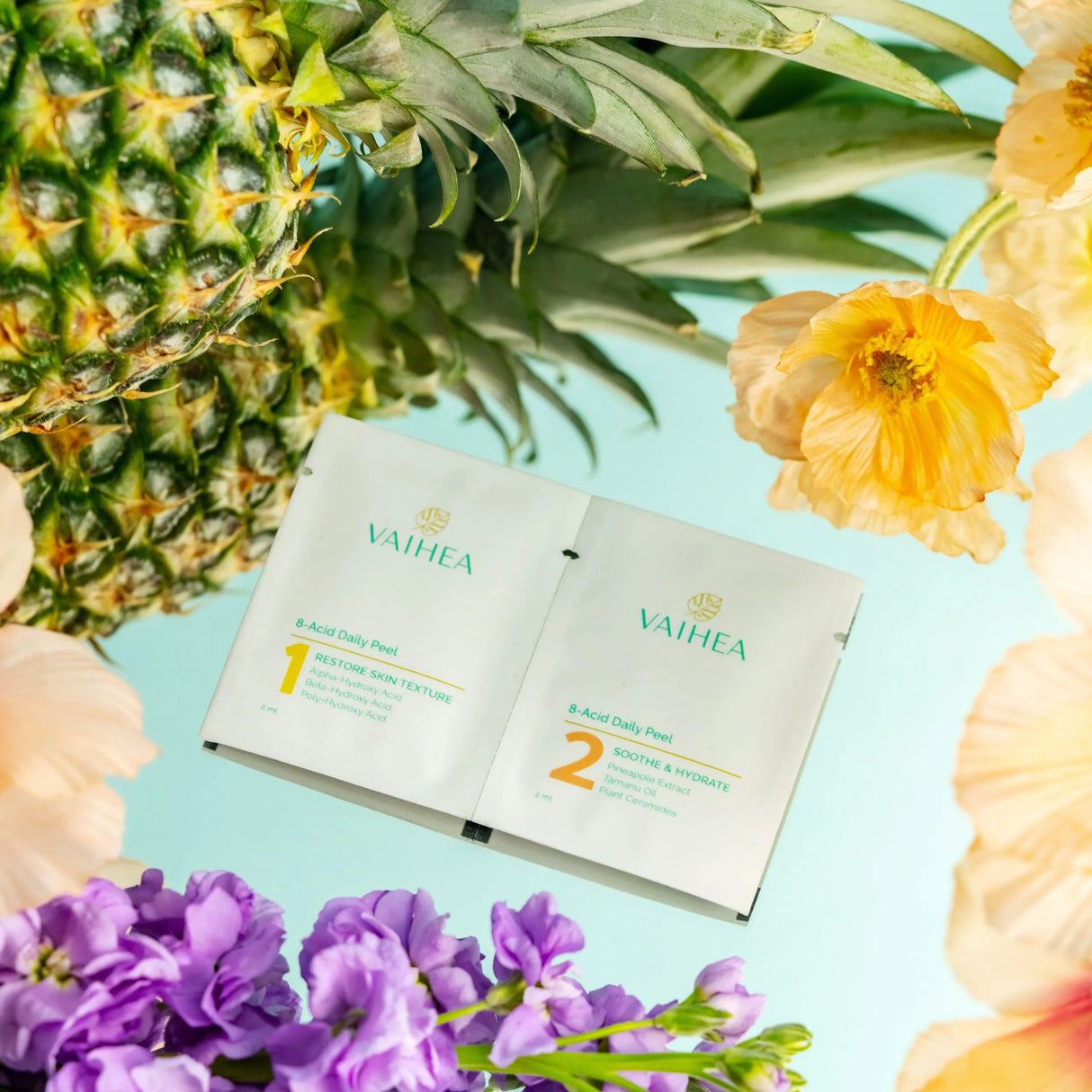 Vaihea skincare product packaging with a pineapple and flowers on a light blue background