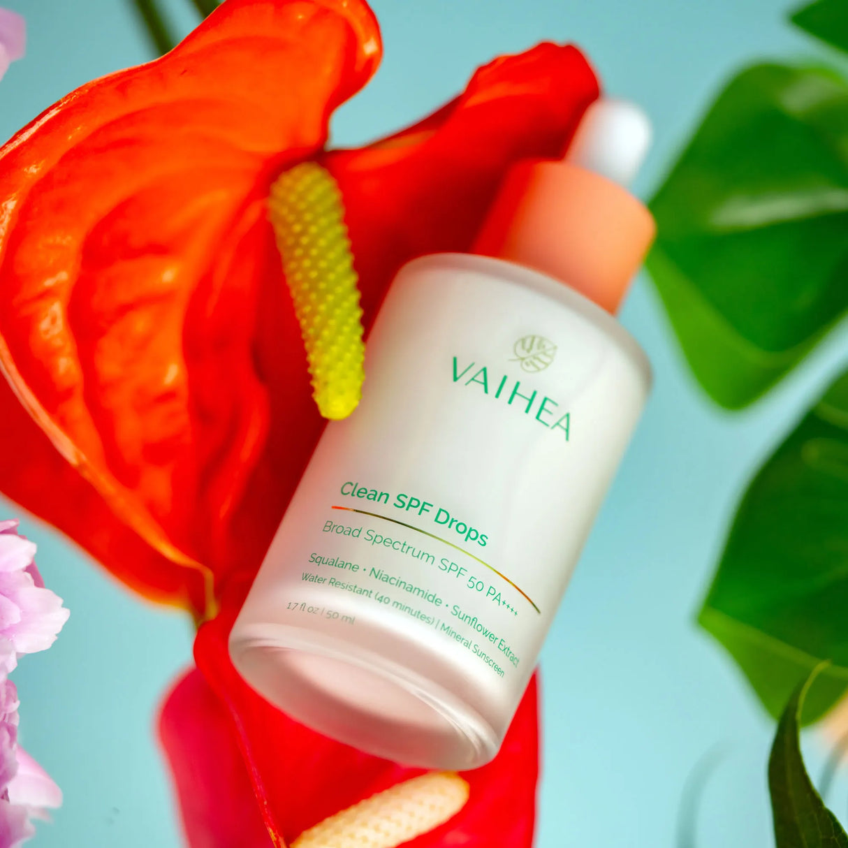 Vatheas skincare product with a red flower in the background