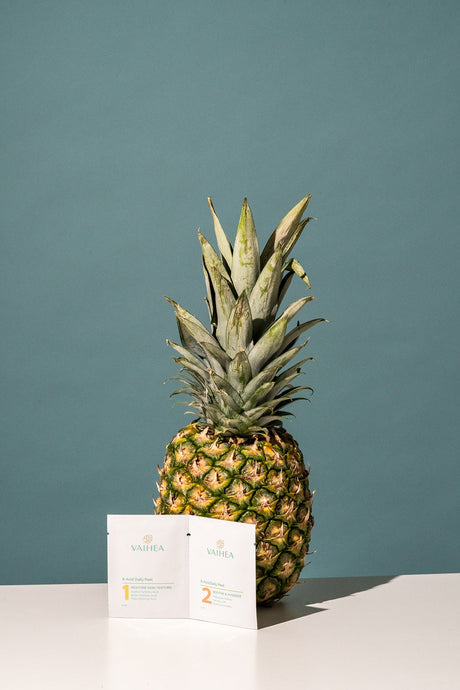 Pineapple on a white surface with a teal background