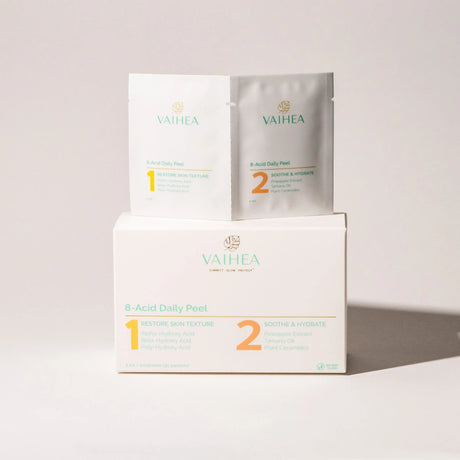 Vaihea skincare products including a box, packets, and a sheet on a light gray background