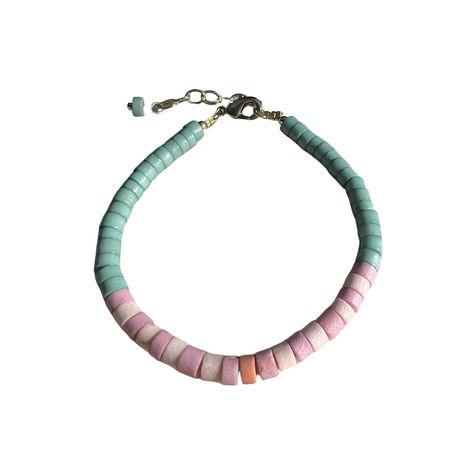 Bracelet with pastel-colored beads on a white background