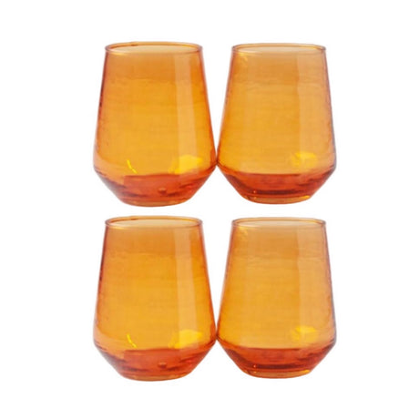 Four amber stemless wine glasses on a white background