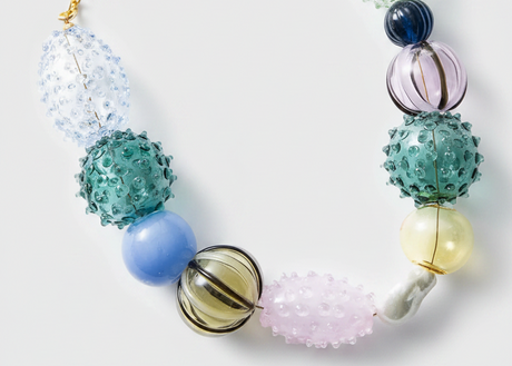 Necklace with multicolored beads on a white background