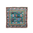 Decorative square pillow with floral pattern on a white background
