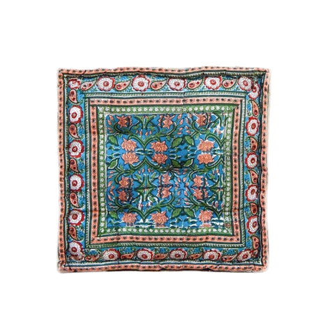 Decorative square pillow with floral pattern on a white background