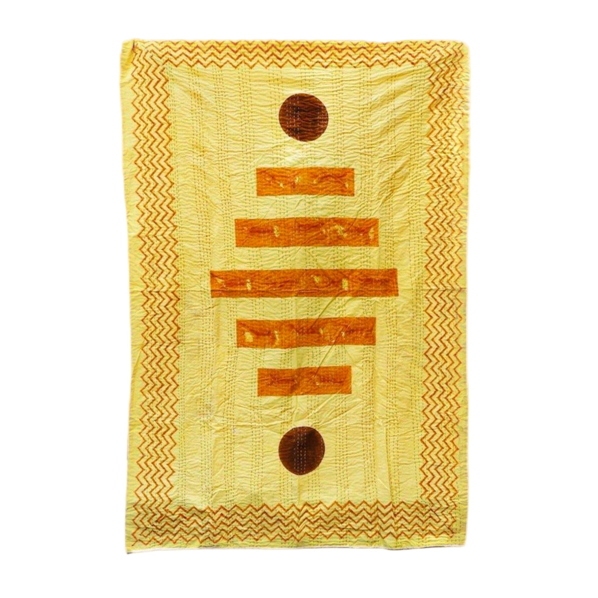 Yellow quilt with brown circular patterns on a white background