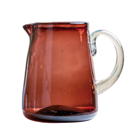 Amber glass pitcher on a white background