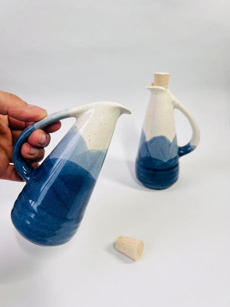 Ceramic pitcher with blue and white gradient on a light gray background