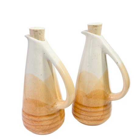 Two ceramic pitchers with a gradient design on a white background