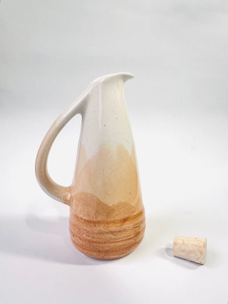 Ceramic pitcher with a natural finish on a white background