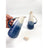 Ceramic pitcher with blue and white gradient held by a hand on a white background
