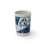 This exquisite blue and white ceramic cup, the Adorable Cat 1 Tea Cup, is a fine example of Mino-ware, showcasing a charming cat design set against a striking black background.