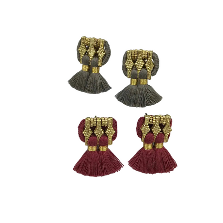 Pair of tassel earrings with gold and maroon design on a white background