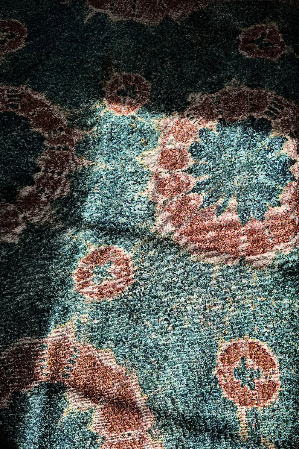 Bohemian cotton throw blanket featuring an organic tie-dye effect in deep blue and warm rust.
