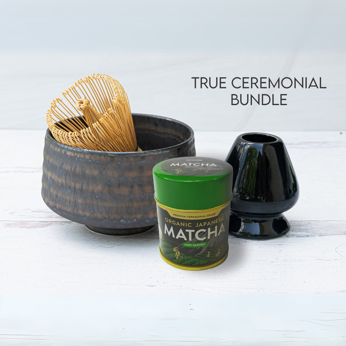 The Kaneni Gold Crystal Ceramic Matcha Bowl is a ceramic piece from the set, crafted with traditional Minoyaki pottery techniques and displayed with a bamboo whisk, matcha tin, and black ceramic holder on a light surface.