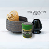 The Kaneni Gold Crystal Ceramic Matcha Bowl is a ceramic piece from the set, crafted with traditional Minoyaki pottery techniques and displayed with a bamboo whisk, matcha tin, and black ceramic holder on a light surface.