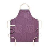 Purple apron with three pockets on a white background
