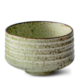 This Kaneni White Ceramic Matcha Bowl, reminiscent of Japanese pottery, features a green textured surface and a slightly darker rim—perfect as a matcha accessory to complement your set.