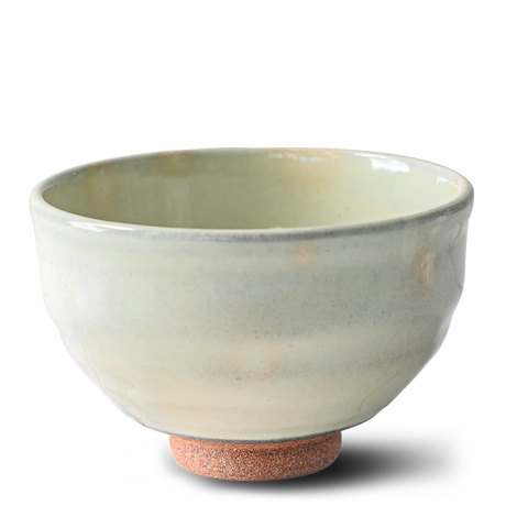 The Kohiki White Clay Matcha Bowl with a textured base, part of a set including a bamboo whisk, whisk holder, and organic Japanese matcha, is displayed against a white background.