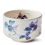 Explore the elegance of Minoyaki pottery with this ceramic matcha bowl from the White Clay Kudzu Flowers Matcha Set. Featuring blue and pink floral designs on white, it perfectly complements your Japanese artistry-inspired matcha starter set.