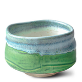 The Iguchi Deep Sea Clay Matcha Bowl features a wide brim and smooth texture in green and blue, reflecting the fine craftsmanship of Minoyaki pottery.