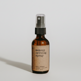 Makeup setting spray bottle with a brown label on a white background