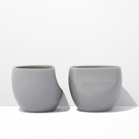 Two gray ceramic cups on a white background