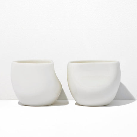 Two white ceramic cups on a white background