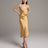 Woman wearing a gold slip dress against a plain background