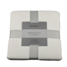 Folded Newcastle blanket with a label on a white background