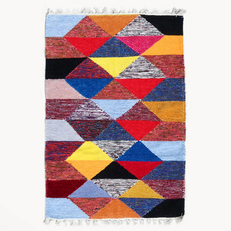 Multicolored geometric patterned rug on a white background