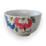 The Red and Blue Flowers Matcha Bowl features vibrant floral patterns on a white background, pairing perfectly with a bamboo matcha whisk for an ideal matcha tea set experience.