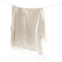 Beige throw blanket with fringe on a white background