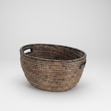 Woven basket with two handles on a light gray background