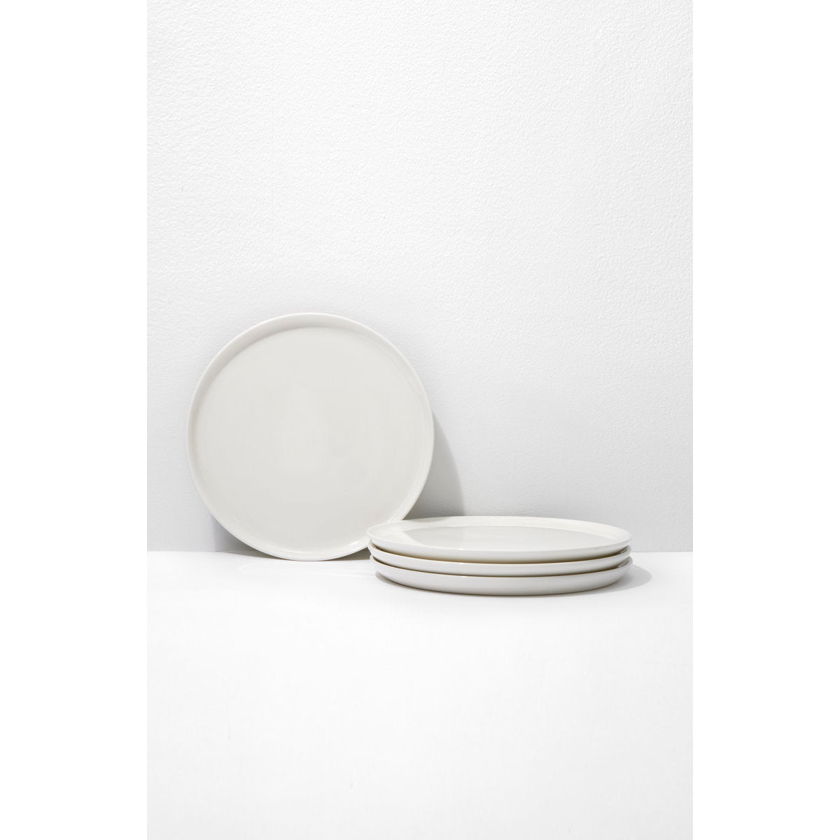 Set of white ceramic plates on a white background
