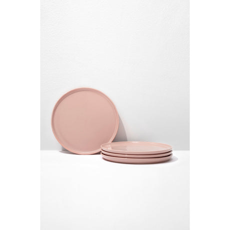 Set of pink ceramic plates on a white background