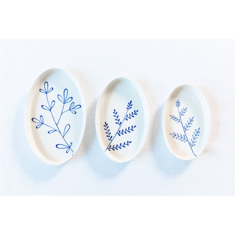 Three ceramic plates with blue floral patterns on a white background. Süheyla Nesting Plates