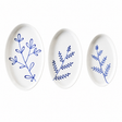 Three oval ceramic plates with blue leaf patterns on a white background. Süheyla Nesting Plates