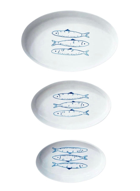 Three white plates with blue fish illustrations on a white background