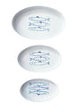 Three white plates with blue fish illustrations on a white background