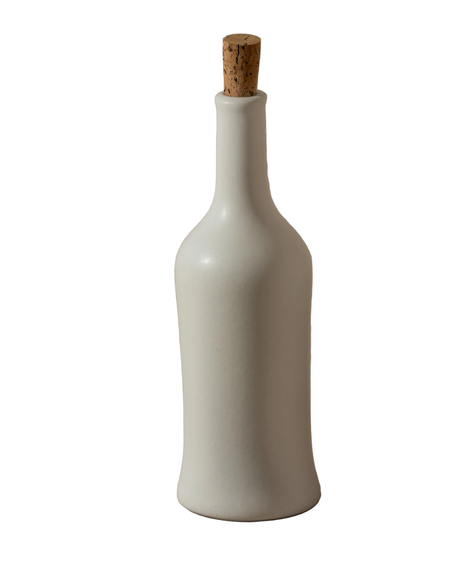 White ceramic bottle with a cork on a white background