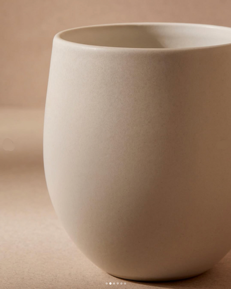 Beige ceramic cup on a beige background