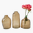 Three brown glass vases with a single pink rose on a white background
