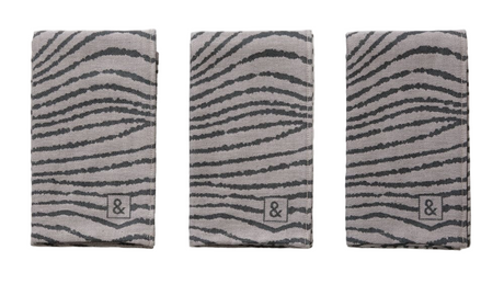 Three gray towels with zebra stripe pattern and brand logo on a white background